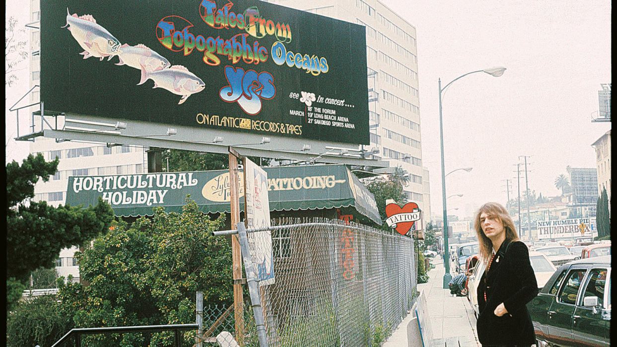  Howe poses near a Topographic Oceans billboard advert in one of Roger Dean’s photos from the early part of 1974’s U.S. tour. 