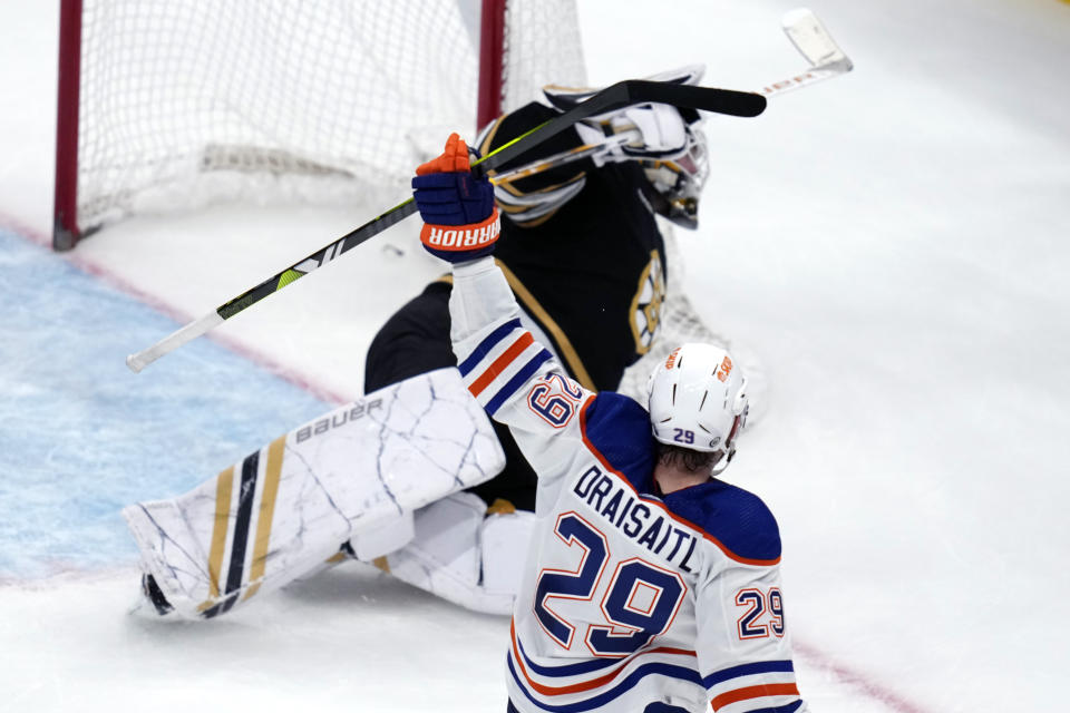 Edmonton Oilers center Leon Draisaitl (29) raises his stick after his goal against Boston Bruins goaltender Linus Ullmark in overtime of an NHL hockey game Tuesday, March 5, 2024, in Boston. The Oilers won 2-1. (AP Photo/Charles Krupa)