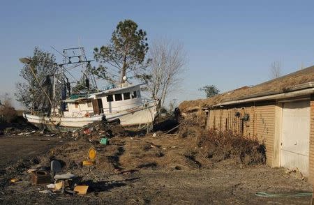 A commercial fishing boat lies on a residential street in St. Bernard Parish east of New Orleans, Louisiana, November 2, 2005. REUTERS/Lucas Jackson