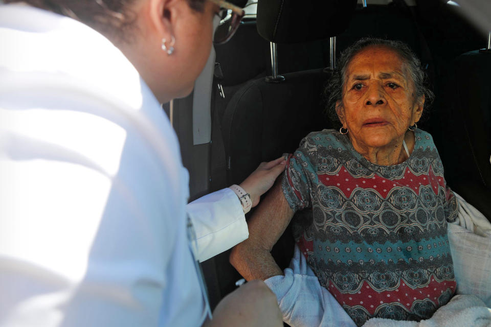 Dima Radilla, 92, receives a flu vaccination during a drive-through clinic in Garden City, Ga., on Nov. 22, 2022. (Richard Burkhart / Savannah Morning News / USA Today Network)