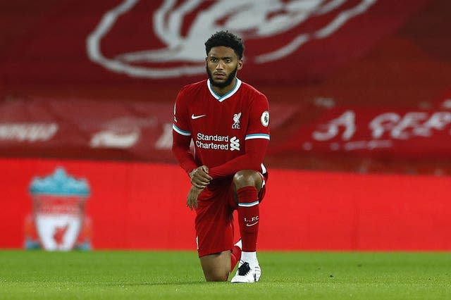 Liverpool centre-back Joe Gomez takes a knee 