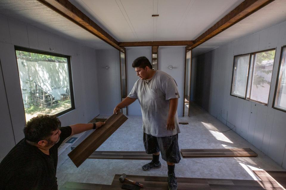 Darío Medina, left, and his son Carlos work construction together in Texas. Carlos Medina's dream of going to welding school has been put on hold because his Deferred Action for Childhood Arrivals petition stalled as the case was being heard in the court system.