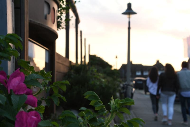 People walk outside the "Pony" club in Kampen (Sylt) on Friday evening. A video shared online of young Germans chanting racist anti-immigrant slogans outside a pub on the North Sea island of Sylt has sparked outrage in the country. Lea Sarah Albert/dpa