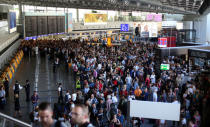 People gather at Frankfurt airport terminal after Terminal 1 departure hall was evacuated in Frankfurt, Germany, August 31, 2016. REUTERS/Alex Kraus