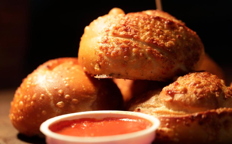 Garlic Knots, breadstick dough knotted with garlic and parmesan, served with a cup of marinara sauce, is one of the new Lambeau Field concession items available for the 2023 season.