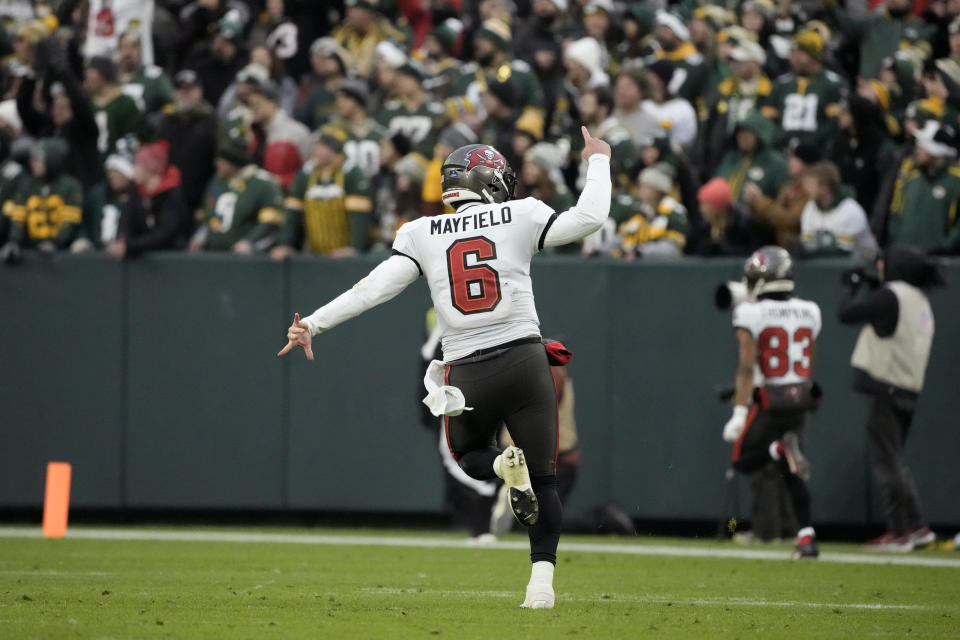 Tampa Bay Buccaneers quarterback Baker Mayfield (6) celebrates after throwing a 52-yard touchdown pass during the second half of an NFL football game against the Green Bay Packers, Sunday, Dec. 17, 2023, in Green Bay, Wis. (AP Photo/Morry Gash)