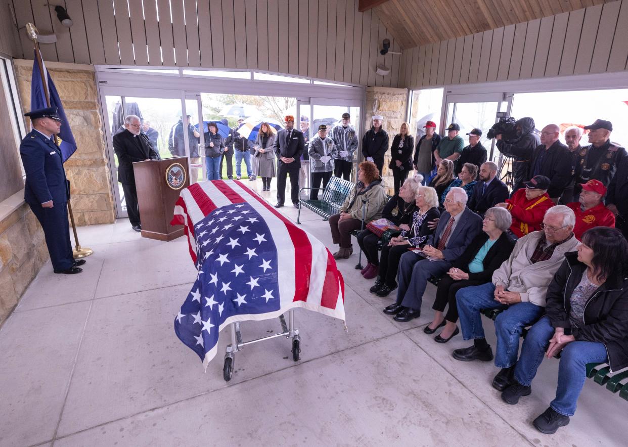 The Rev. Larry Mort (left) delivers remarks Thursday during the U.S. military funeral service of Navy Fireman 1st Class Walter Schleiter of Massillon at National Cemeteries of the Alleghanies.