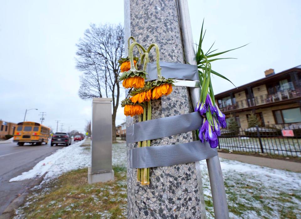 A few wilted flowers are taped to a pole near North 76th and West Congress Streets, in Milwaukee on Friday, Feb. 2, 2024, where Jolene Waldref, 49, of South Milwaukee, fell and died of hypothermia at a bus stop in subzero temperatures on Jan. 15.