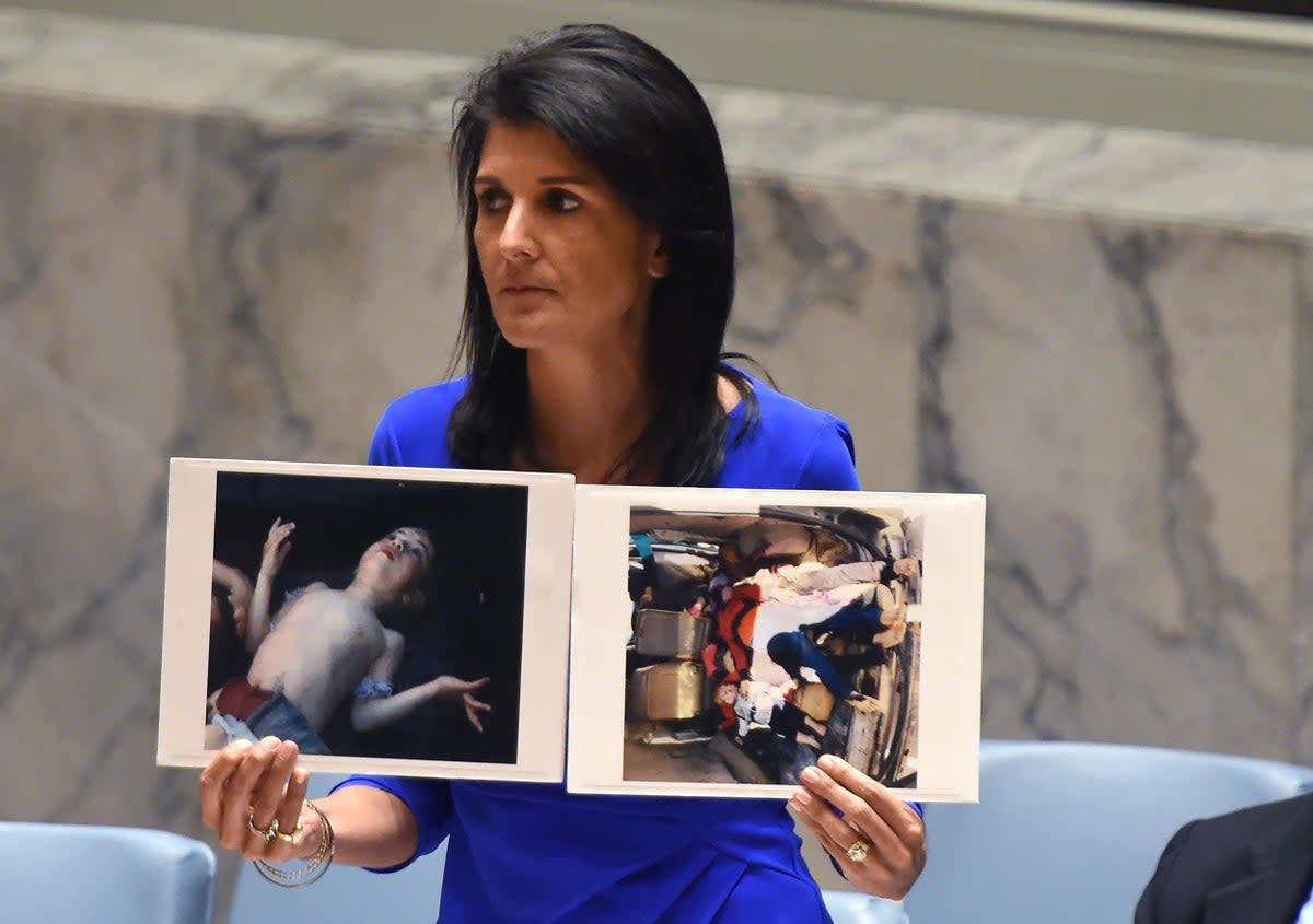 Nikki Haley, US ambassador to the UN, with photos of victims killed in chemical weapons attacks as she speaks during an emergency session at the UN about Syria in 2017 (Getty)