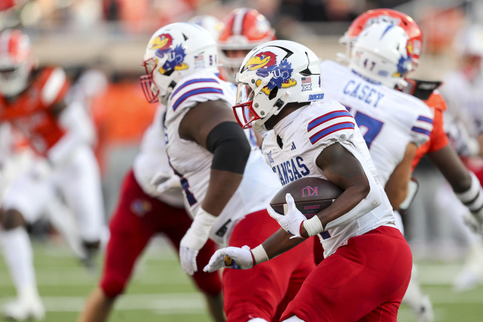 Kansas's Devin Neal runs the ball during the second half of an NCAA college football game against Oklahoma State in Stillwater, Okla., Saturday, Oct. 14, 2023. (AP Photo/Mitch Alcala)