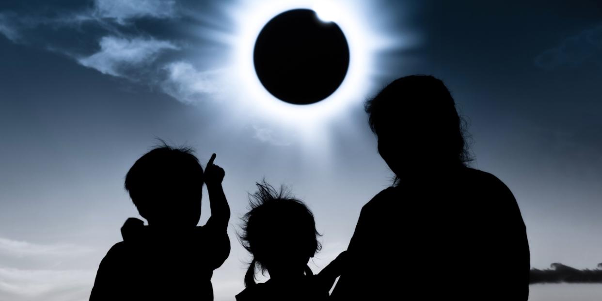 family watching total solar eclipse