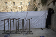 An ultra-Orthodox Jewish man prays ahead of the Jewish new year at the Western Wall, the holiest site where Jews can pray in Jerusalem's old city, Wednesday, Sept. 16, 2020. A raging coronavirus outbreak is casting a shadow over the normally festive Jewish New Year. With health officials recommending a nationwide lockdown, traditional family gatherings will be muted, synagogue prayers will be limited to small groups and roads will be empty. (AP Photo/Sebastian Scheiner)