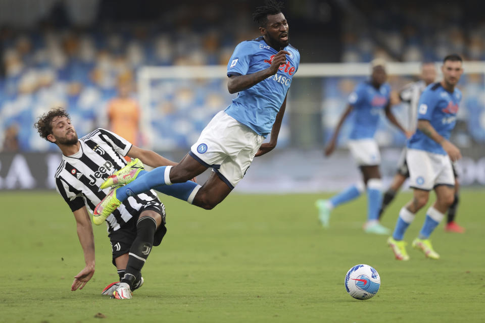 Juventus' Manuel Locatelli, left, and Napoli's Andre Frank Zambo Anguissa vie for the ball during the Italian Serie A soccer match between Napoli and Juventus at the Diego Maradona stadium in Naples, Italy, Saturday, Sept. 11, 2021. (Alessandro Garofalo/LaPresse via AP)