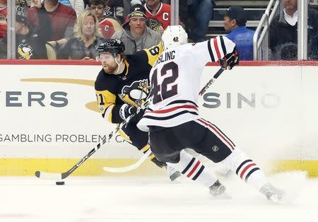 Nov 18, 2017; Pittsburgh, PA, USA; Pittsburgh Penguins right wing Phil Kessel (81) handles the puck against Chicago Blackhawks defenseman Gustav Forsling (42) during the second period at PPG PAINTS Arena. Chicago won 2-1. Mandatory Credit: Charles LeClaire-USA TODAY Sports