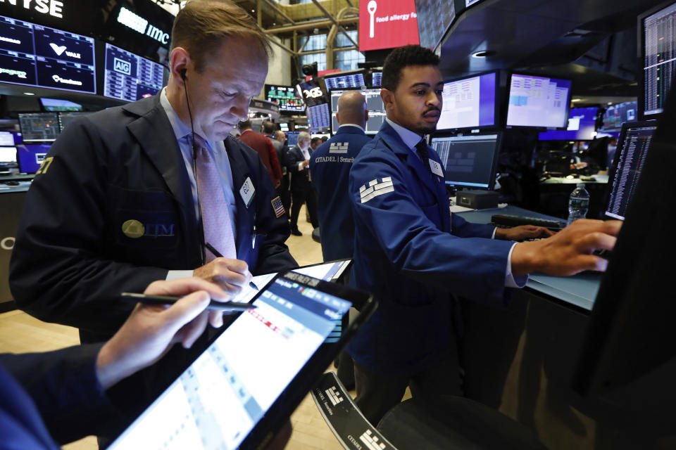 Trader Michael Smyth, left, and specialist Christopher Riggs work on the floor of the New York Stock Exchange, Thursday, May 30, 2019. Stocks are edging higher in early trading on Wall Street following two days of losses. (AP Photo/Richard Drew)