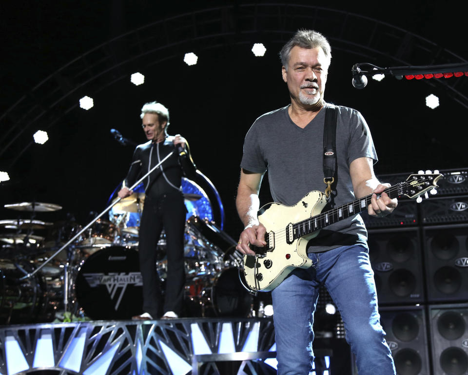 FILE - David Lee Roth, left, and Eddie Van Halen of Van Halen perform on Aug. 13, 2015, in Wantagh, N.Y. Van Halen, who had battled cancer, died Tuesday, Oct. 6, 2020. He was 65. (Photo by Greg Allen/Invision/AP, File)