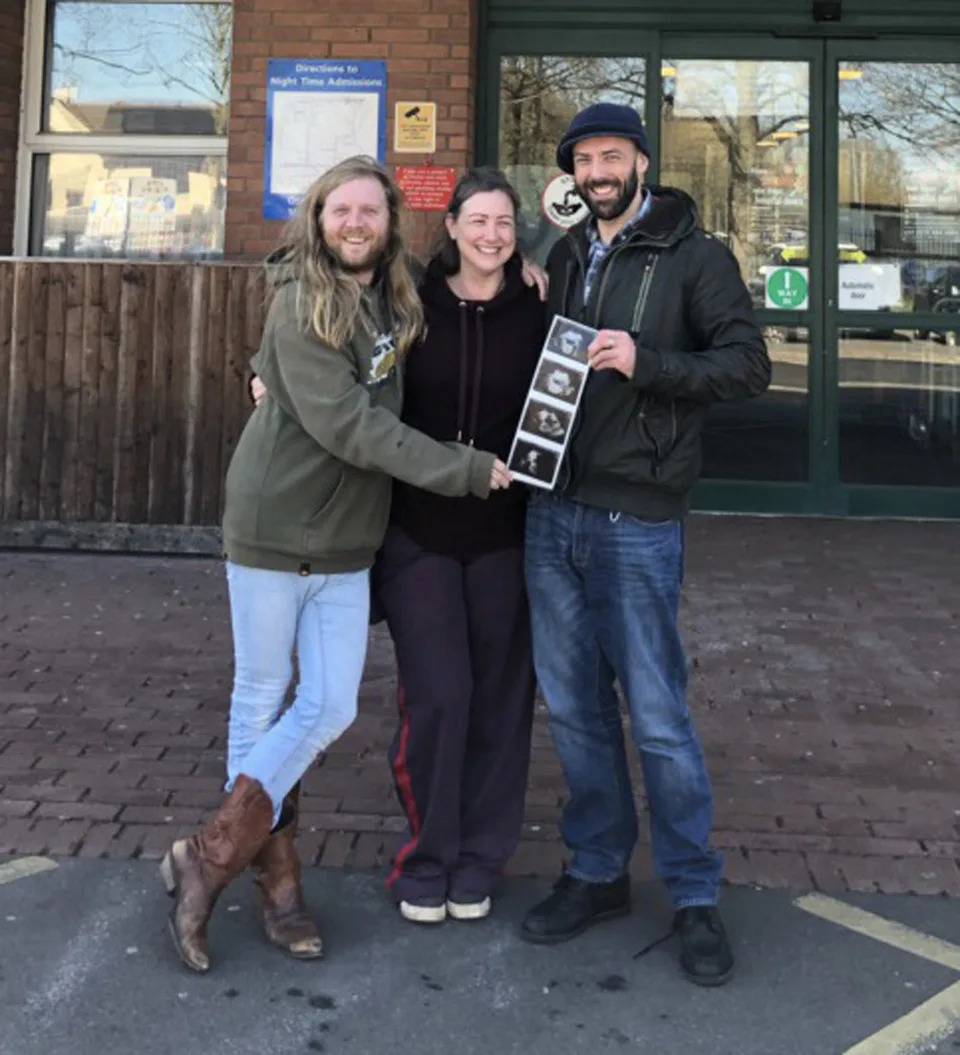 David Watkins with his surrogate Faye Spreadbury and her husband Lee at the 20 week scan. (Caters)