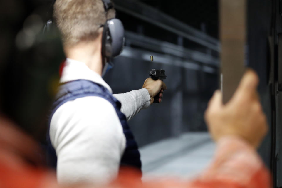 Chicago resident Ray Mandel practices shooting during a session at Maxon Shooter's Supplies and Indoor Range, Friday, April 30, 2021, in Des Plaines, Ill. After a year of pandemic lockdowns, mass shootings are back, but the guns never went away. As the U.S. inches toward a post-pandemic future, guns are arguably more present in the American psyche and more deeply embedded in American discourse than ever before. The past year's anxiety and loss fueled a rise in gun ownership across political and socio-economic lines. (AP Photo/Shafkat Anowar)