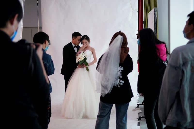 Peng Jing, 24, and Yao Bin, 28, pose for their wedding photography shoot after the lockdown was lifted in Wuhan