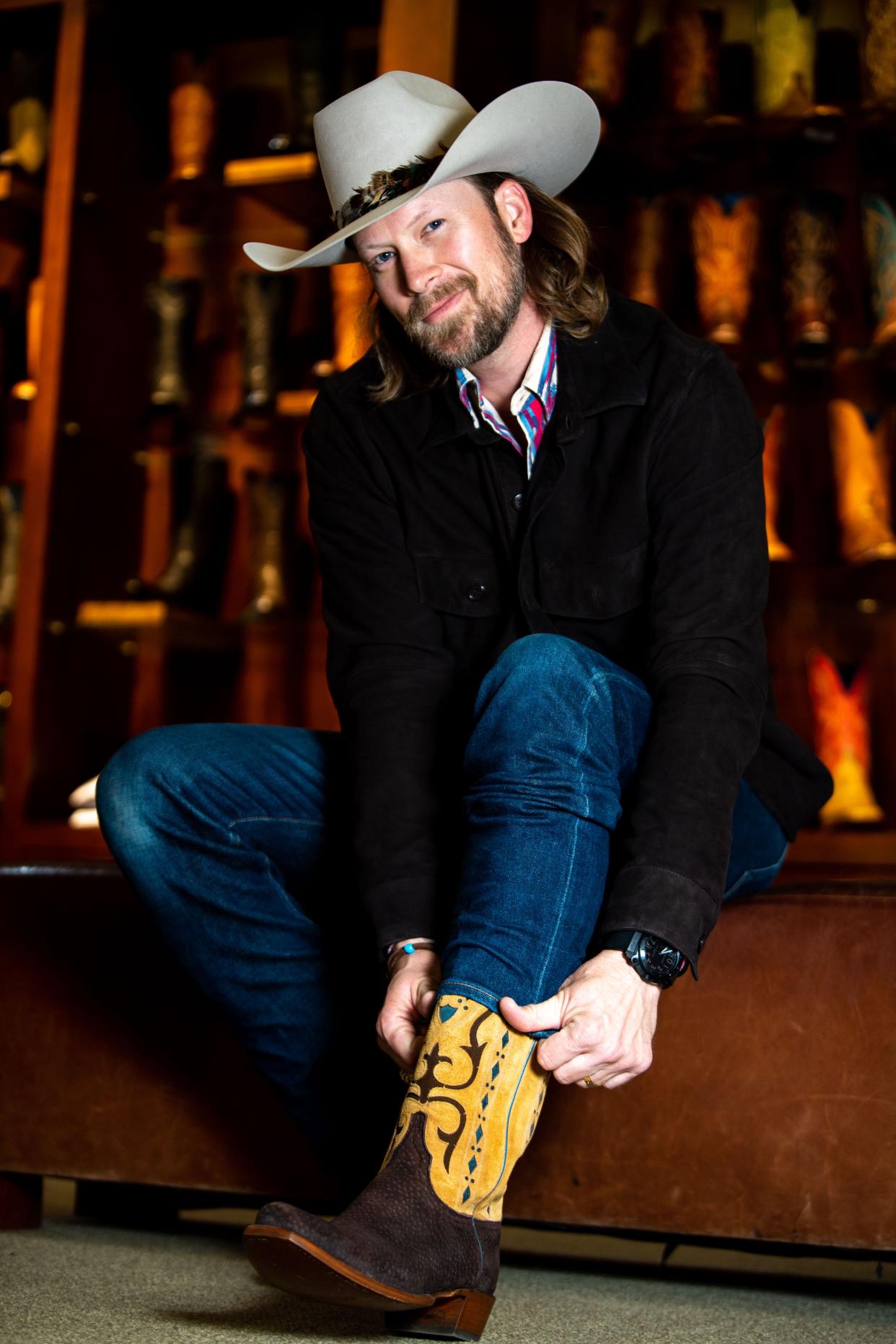 Brian Kelley tries on a pair of boots at Lucchese's store in downtown Nashville.