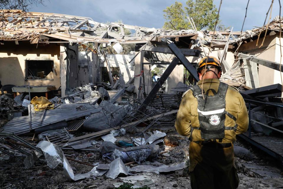 A rocket hit a house in a community north of Tel Aviv and caused it to catch fire. (AFP/Getty Images)