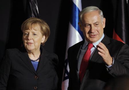 Israel's Prime Minister Benjamin Netanyahu (R) stands next to German Chancellor Angela Merkel after their joint news conference in Jerusalem February 25, 2014. Germany views Iran as a potential threat not just to Israel, but also to European countries, Merkel said on Tuesday at a joint news conference with Netanyahu. REUTERS/Ammar Awad