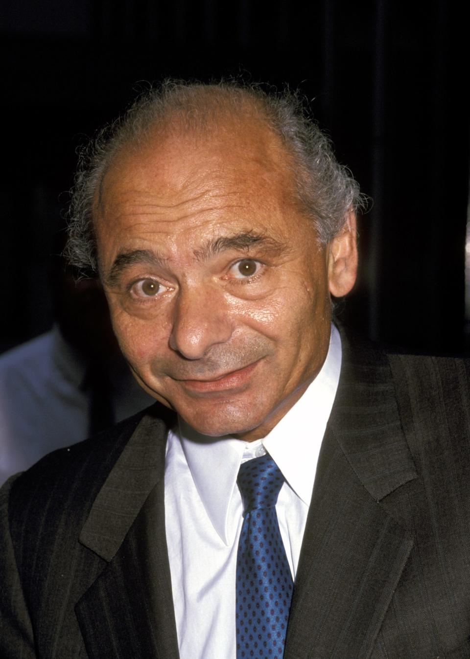 Burt Young in a suit and tie