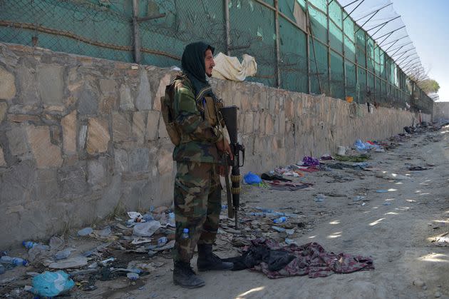 A Taliban fighter stands guard at the site of the August 26 twin suicide bombs, which killed scores of people including 13 US troops, at Kabul airport on August 27, 2021 (Photo: WAKIL KOHSAR via Getty Images)