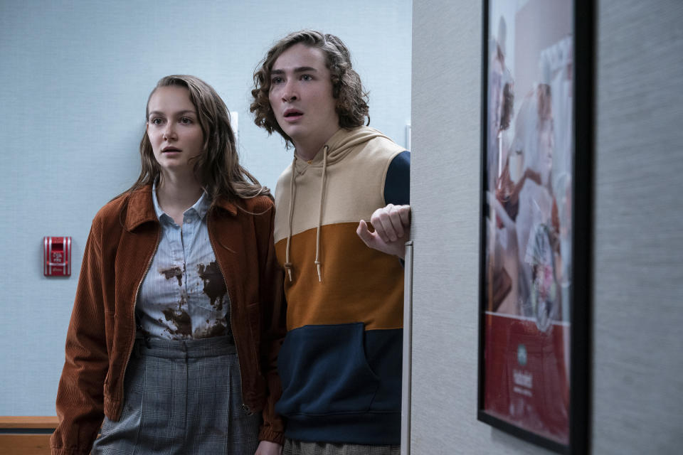 This image released by Universal Pictures shows Andi Matichak, left, and Dylan Arnold in "Halloween Kills," directed by David Gordon Green. (Ryan Green/Universal Pictures via AP)