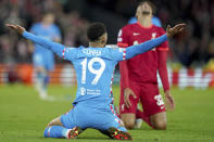 Atletico Madrid's Matheus Cunha, left, and Liverpool's Joel Matip react during the Champions League group B soccer match between Liverpool and Atletico Madrid in Liverpool, England, Wednesday, Nov. 3, 2021.(AP Photo/Jon Super)