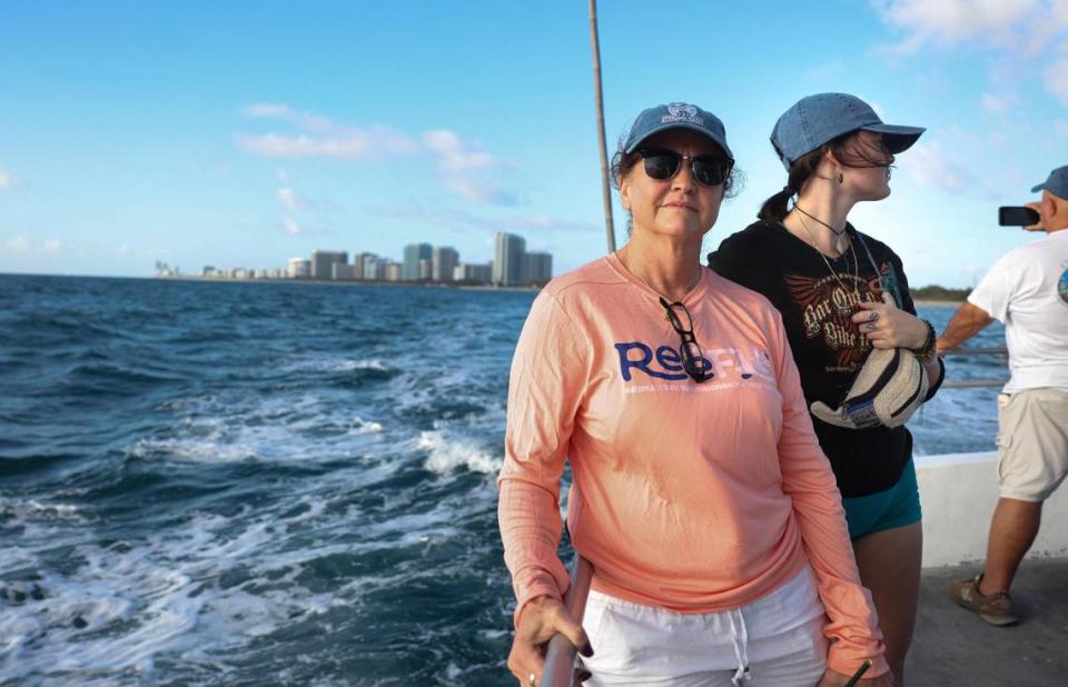 Debbie Pace, center, and her daughter Lexi, 21, ride on a boat to a ceremony honoring Jeffrey Neil Pace, Debbie’s husband and Lexi’s father who died of pancreatic cancer in 2022.