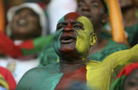 FILE- A man painted in the colours of the Cameroon flag, chants, prior to the African Cup of Nations Group D soccer match between Cameroon and Ivory Coast, at Estadio De Malabo, in Malabo, Equatorial Guinea, on Jan. 28, 2015. (AP Photo/Sunday Alamba, File)