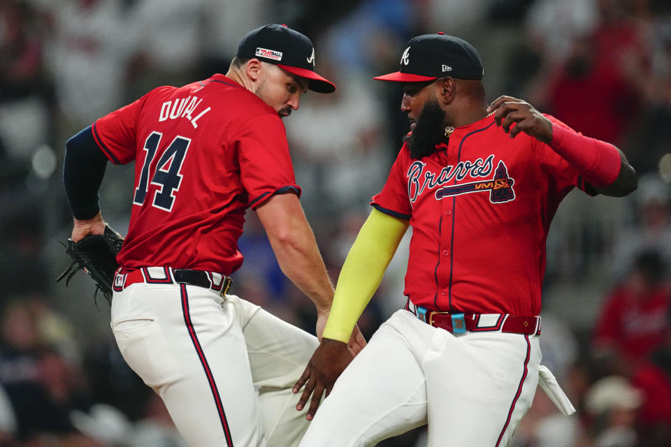 Atlanta Braves' Marcell Ozuna, right, and Adam Duvall (14) celebrate after defeating the the Tampa Bay Rays in a baseball game Friday, June 14, 2024, in Atlanta. (AP Photo/John Bazemore)