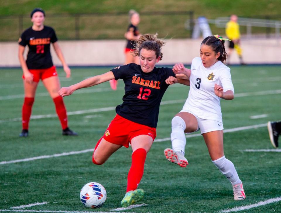 Oakdale High’s Dakota Burford, 12, fights for control of the ball against Hannah Hopkins, 3, of Rio Americano High during the Sac-Joaquin Section Division III Section Championship match Thursday Feb. 22, 2024 at Cosumnes River College.