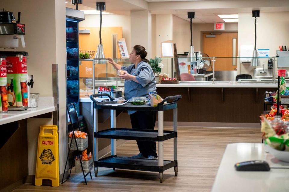 A cafeteria worker restocks for lunch at the George Regional Health System’s hospital in Lucedale, Mississippi. The cafeteria was expanded with $1 million from the state.