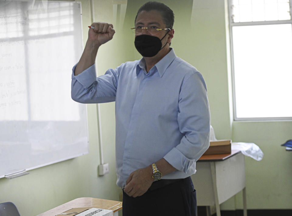 Presidential candidate Rodrigo Chaves pumps his fist after casting his ballot at a polling station during a runoff presidential election, in San Jose, Costa Rica, Sunday, April 3, 2022. Rodrigo Chaves a treasury minister from Costa Rica's outgoing administration and Jose Maria Figueres a former president, face off to become the country's next leader. (AP Photo/Carlos Gonzalez)