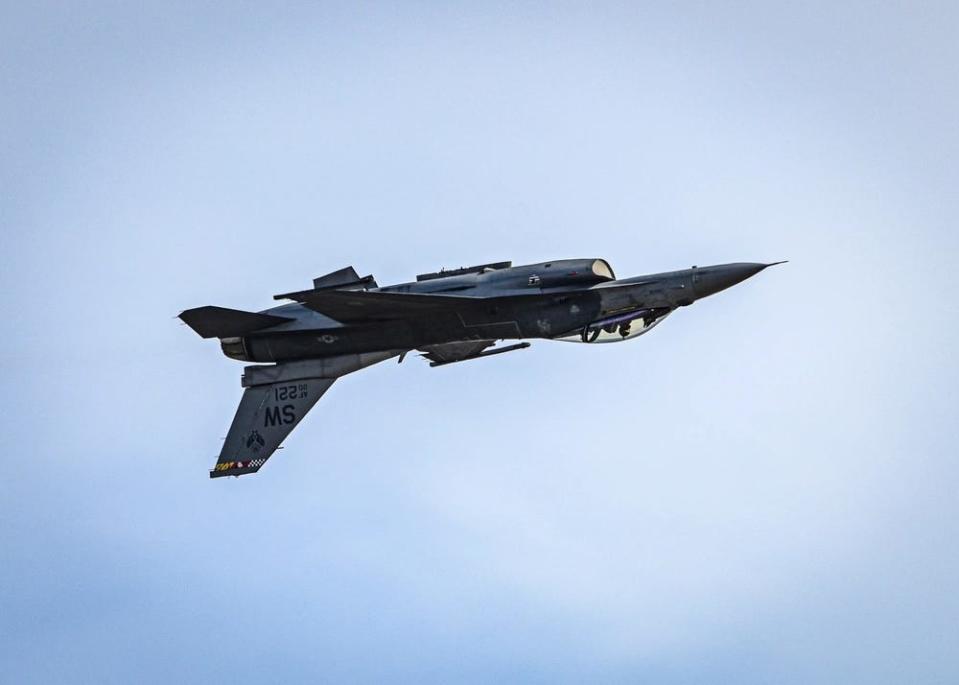 an upside-down fighter jet performing a maneuver mid-flight