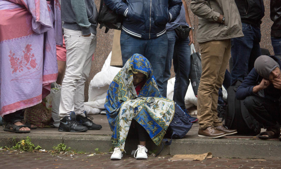 FILE - In this Sept. 1, 2015 file photo, a young child waits in line at a migrant reception center in Brussels. Belgian migration minister Theo Francken on Thursday, Dec. 6, 2018 said he wants no part of a United Nations pact on safe and orderly migration, an international deal that has pushed Belgium's government to the brink of collapse. (AP Photo/Virginia Mayo, File)