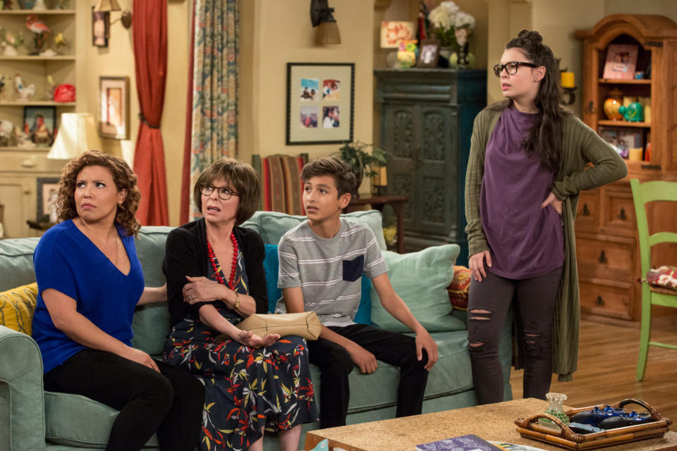 Justina Machado, Rita Moreno, Marcel Ruiz, and Isabella Gomez in a living room in a scene from "One Day At a Time"