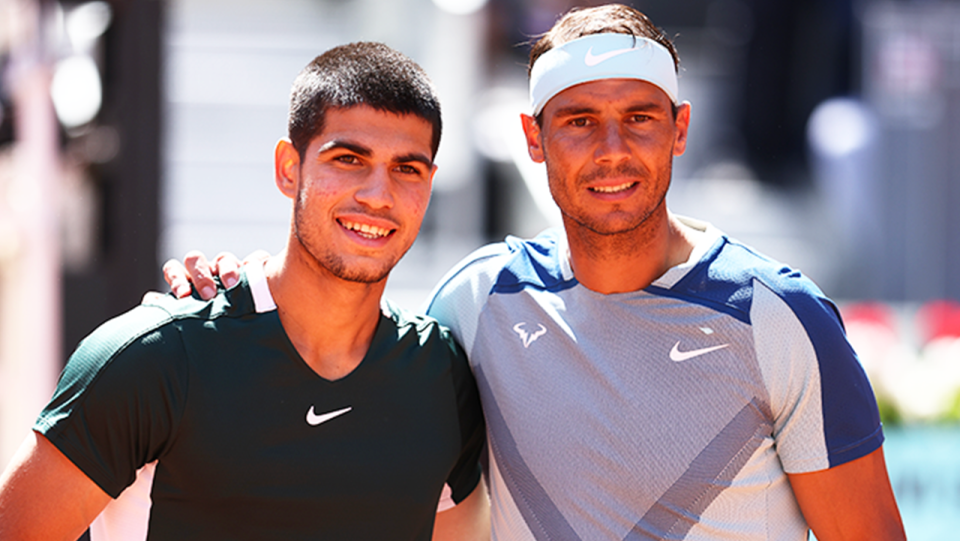 Rafa Nadal (pictured right) and Carlos Alcaraz (pictured left) embrace at the net.