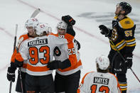 Philadelphia Flyers left wing James van Riemsdyk (25) celebrates his goal with right wing Jakub Voracek (93) as Boston Bruins defenseman Jeremy Lauzon (55) looks up at the replay during the second period of an NHL hockey game Thursday, Jan. 21, 2021, in Boston. (AP Photo/Elise Amendola)