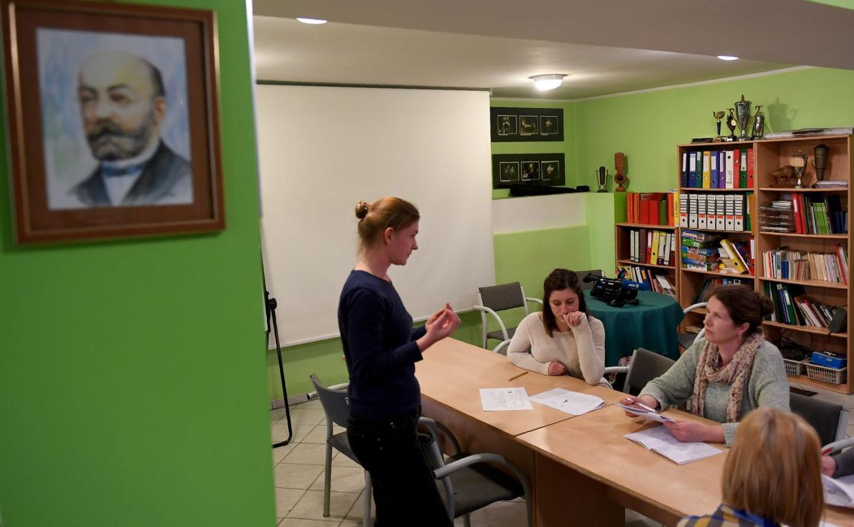 An Esperanto teacher instructs a class in a room with a painting of the language's creator on the wall. <a href="https://www.gettyimages.com/detail/news-photo/esperanto-teacher-iwona-zalewska-instructs-a-class-of-news-photo/667892248" rel="nofollow noopener" target="_blank" data-ylk="slk:Janek Skarzynski/AFP via Getty Images;elm:context_link;itc:0;sec:content-canvas" class="link ">Janek Skarzynski/AFP via Getty Images</a>