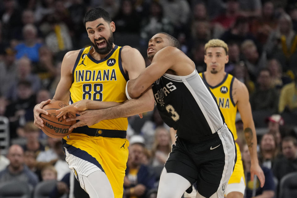 Indiana Pacers center Goga Bitadze (88) steals the ball from San Antonio Spurs forward Keldon Johnson (3) during the second half of an NBA basketball game in Indianapolis, Friday, Oct. 21, 2022. (AP Photo/AJ Mast)