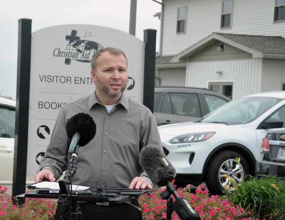 Christian Aid Ministries spokesperson Weston Showalter reads a letter from the victims of the Haiti kidnappings during an Oct. 21 news conference outside CAM headquarters in Holmes County.