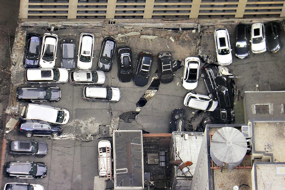 Cars are seen at the partial collapse of a parking garage in the Financial District of New York, Wednesday, April 19, 2023, in New York. The parking garage collapsed Tuesday in lower Manhattan’s Financial District, killing one worker, injuring five and crushing cars as concrete floors fell on top of each other like a stack of pancakes, officials said. (Tom Kaminski/WCBS 880 News via AP)