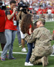 <p>Ann Bryant, left, looks on with anticipation as her husband, U.S. Navy Lt. Commander Donald Bryant, greets their children Arielle and Tristan during the first quarter of an NFL football game between the Tampa Bay Buccaneers and the Green Bay Packers, Sunday, Dec. 21, 2014, in Tampa, Fla. Bryant surprised his family at the game after a deployment in Afghanistan. (AP Photo/Brian Blanco) </p>