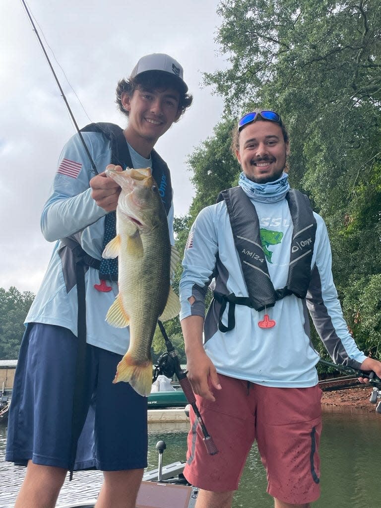 Hunter Schouest, left, and Cody Pellegrin show off their 4-pound largemouth bass Thursday, Aug. 11, 2022, at the Bassmaster High School National Championship in Greenville, South Carolina.