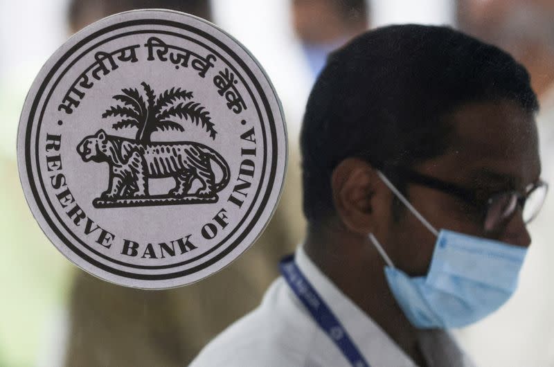 A man walks past the logo of Reserve Bank of India (RBI) inside its headquarters in Mumbai