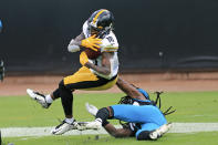 Pittsburgh Steelers wide receiver Diontae Johnson, left, makes a reception despite defensive effort by Jacksonville Jaguars cornerback Tre Herndon, right, during the first half of an NFL football game, Sunday, Nov. 22, 2020, in Jacksonville, Fla. (AP Photo/Matt Stamey)