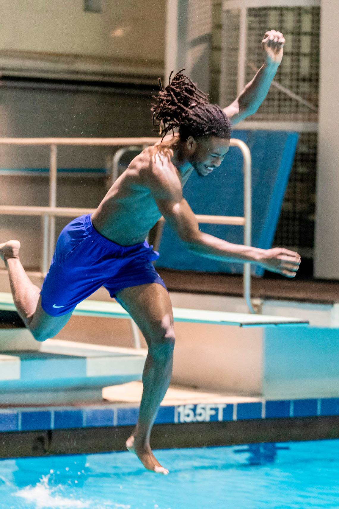 Cason Wallace jumps off a diving board at the Lancaster Aquatic Center on UK’s campus.